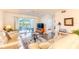 Bright living room with sliding glass doors to balcony and an adjacent view into the bedroom at 5725 Greenwood Ave # 3104, North Port, FL 34287