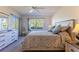 Light-filled bedroom with a comfortable bed, dresser, and a large window with natural light at 5725 Greenwood Ave # 3104, North Port, FL 34287