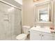 Bright bathroom with a glass-enclosed shower, toilet, sink, and a mirror at 623 Oak Hill Cir # 28, Sarasota, FL 34232