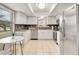 Bright kitchen featuring white cabinets, stainless steel appliances, and a stylish backsplash at 623 Oak Hill Cir # 28, Sarasota, FL 34232