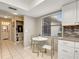 Eat-in kitchen featuring white cabinets, stainless steel appliances, and tiled flooring at 623 Oak Hill Cir # 28, Sarasota, FL 34232