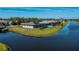 Aerial view of the waterfront homes with beautiful landscaping and water views at 855 Rotonda Cir, Rotonda West, FL 33947