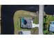 Aerial view of a home with pool, solar panels, and well-manicured lawn at 855 Rotonda Cir, Rotonda West, FL 33947