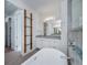 Bathroom features a soaking tub, granite vanity, modern lighting and industrial shelving at 855 Rotonda Cir, Rotonda West, FL 33947