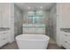 Elegant bathroom featuring a soaking tub, a glass-enclosed shower, and dual vanities at 855 Rotonda Cir, Rotonda West, FL 33947