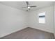 Bedroom featuring a ceiling fan, light gray floors, and a large window for natural light at 855 Rotonda Cir, Rotonda West, FL 33947