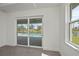 Bedroom boasts sliding glass doors with views of the pool and waterfront at 855 Rotonda Cir, Rotonda West, FL 33947