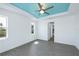 Bright bedroom features a blue accent tray ceiling and modern gray-toned flooring at 855 Rotonda Cir, Rotonda West, FL 33947