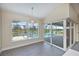 Dining room with windows and sliding glass doors with water view at 855 Rotonda Cir, Rotonda West, FL 33947