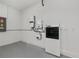 Bright garage area with electrical panel and power storage system at 855 Rotonda Cir, Rotonda West, FL 33947