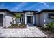 Front entrance with decorative accents and a paved walkway at 855 Rotonda Cir, Rotonda West, FL 33947