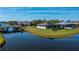 Waterfront home featuring beautiful landscaping, screened patio, and canal access at 855 Rotonda Cir, Rotonda West, FL 33947