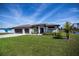 Beautiful home with a well maintained lawn, three car garage and manicured landscaping at 855 Rotonda Cir, Rotonda West, FL 33947