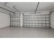 Spacious two car garage featuring epoxy floors and white doors at 855 Rotonda Cir, Rotonda West, FL 33947