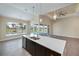 Kitchen featuring large island with sink and stainless steel appliances with a water view at 855 Rotonda Cir, Rotonda West, FL 33947