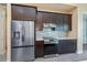Modern kitchen featuring stainless steel appliances and dark cabinetry at 855 Rotonda Cir, Rotonda West, FL 33947