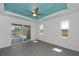 Bright main bedroom with pool access through sliding doors and an elegant ceiling fan at 855 Rotonda Cir, Rotonda West, FL 33947
