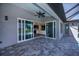 Expansive brick patio area with large sliding doors to the kitchen and living room at 855 Rotonda Cir, Rotonda West, FL 33947