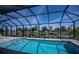 Screened-in pool area with a stunning waterfront view at 855 Rotonda Cir, Rotonda West, FL 33947