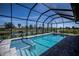 Relaxing pool with a view of the water, surrounded by a screened enclosure at 855 Rotonda Cir, Rotonda West, FL 33947
