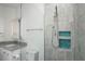 Bathroom shower with gray tiled walls, a built-in shower niche, and glass partition at 855 Rotonda Cir, Rotonda West, FL 33947