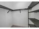 Empty walk-in closet with custom metal shelving and plenty of storage space at 855 Rotonda Cir, Rotonda West, FL 33947
