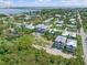 Aerial view showcasing the property's location within a waterfront community and the adjacent, vacant lot at 950 W Olympia Ave, Punta Gorda, FL 33950