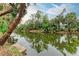 Beautiful view of a calm canal with lush vegetation growing on the banks at 1052 Hinton St, Port Charlotte, FL 33952