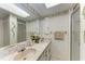 Bathroom featuring dual sinks, a framed mirror, a shower, and tiled floors at 1052 Hinton St, Port Charlotte, FL 33952