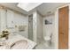 Bathroom with dual sinks, shower, patterned wallpaper, and tiled floors at 1052 Hinton St, Port Charlotte, FL 33952