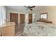 Bedroom with wooden floors, ceiling fan, closet, and doorway to bathroom at 1052 Hinton St, Port Charlotte, FL 33952