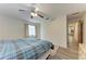 Bright bedroom with wood-look flooring, large window and doorway to an adjacent room at 1052 Hinton St, Port Charlotte, FL 33952