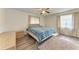 Bedroom featuring wood floors, a ceiling fan, and a comfy bed by the window at 1052 Hinton St, Port Charlotte, FL 33952