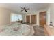 Bedroom boasts wood-look flooring, ceiling fan, and natural light from the window at 1052 Hinton St, Port Charlotte, FL 33952