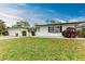 A single-story home with a lawn and garden at 1052 Hinton St, Port Charlotte, FL 33952