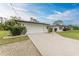 A single-story home with a long driveway leading to the attached two-car garage at 1052 Hinton St, Port Charlotte, FL 33952