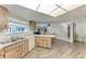 Eat-in kitchen boasts wood cabinets, laminate counters and wood-look floors at 1052 Hinton St, Port Charlotte, FL 33952