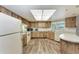 Kitchen with wood cabinets, laminate countertops, recessed lighting, and wood-look floors at 1052 Hinton St, Port Charlotte, FL 33952