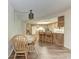 Kitchen and eat-in dining area with matching wood cabinets, floors and chairs at 1052 Hinton St, Port Charlotte, FL 33952