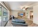 Living room boasts ceiling fan, light wood floors, and sliding doors opening to the lanai at 1052 Hinton St, Port Charlotte, FL 33952
