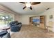 Cozy living room with a ceiling fan, light wood floors and sliding glass door to the lanai at 1052 Hinton St, Port Charlotte, FL 33952