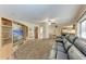An open concept living space with light wood floors and a ceiling fan at 1052 Hinton St, Port Charlotte, FL 33952