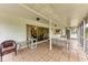 This is a view of the covered patio with tiled floors and outdoor furniture at 1052 Hinton St, Port Charlotte, FL 33952