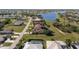 Aerial view of homes near a serene lake, blending community and nature seamlessly at 1225 Neapolitan Rd, Punta Gorda, FL 33983