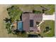 Aerial view of a private home with screened pool, solar panels, landscaping and a driveway to the street at 1225 Neapolitan Rd, Punta Gorda, FL 33983
