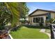 Beautiful backyard with lush landscaping, a fenced perimeter, and artificial turf at 1225 Neapolitan Rd, Punta Gorda, FL 33983