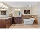 Luxurious bathroom featuring granite countertops, dual sinks, and a modern soaking tub with stylish fixtures at 1225 Neapolitan Rd, Punta Gorda, FL 33983