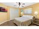 Cozy bedroom featuring a ceiling fan, a large window, and a comfortable bed with decorative bedding at 1225 Neapolitan Rd, Punta Gorda, FL 33983