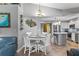 Dining room showcasing a round table with white chairs, and an adjacent kitchen at 1225 Neapolitan Rd, Punta Gorda, FL 33983