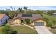 Attractive single-story home with a lush green lawn and mature landscaping with mature palm trees at 1225 Neapolitan Rd, Punta Gorda, FL 33983
